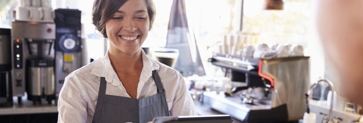 Cashier Takes Card Payment From Customer With Digital Tablet