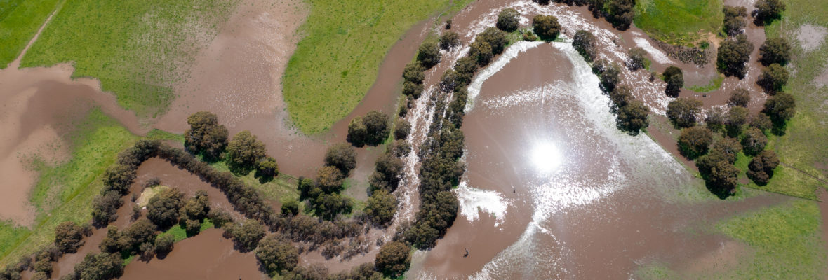 drone shot of farming landscape on a ranch in Australia, of a flooding river.