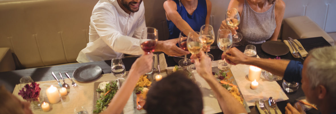 Friends toasting champagne glasses in restaurant